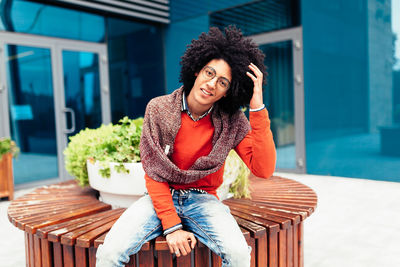 Young woman smiling while sitting on chair