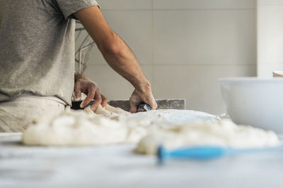 Midsection of man preparing food in kitchen