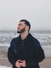 Young man standing at beach