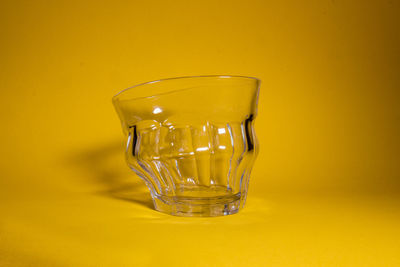 Close-up of wine in glass against yellow background