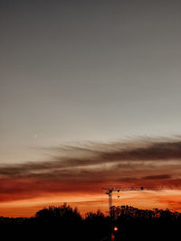 Silhouette trees against sky during sunset