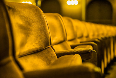 Close-up of yellow seats in row