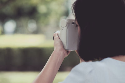 Rear view of woman photographing