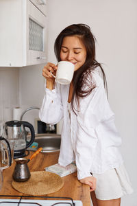 Portrait of young woman using mobile phone