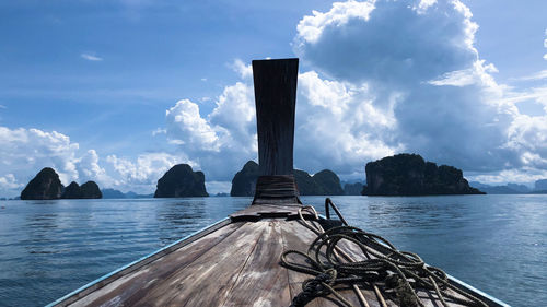 Panoramic view of wooden posts in sea against sky