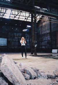 Rear view of woman walking in front of building