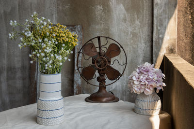 Close-up of flower vase on table at home