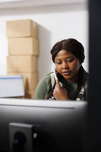 Portrait of young man using laptop at home