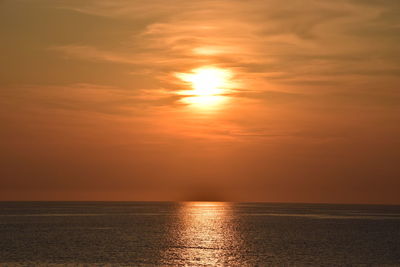 Scenic view of sea against orange sky