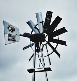 Low angle view of windmill against sky