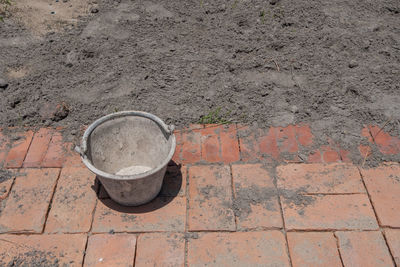 High angle view of old shoes on footpath