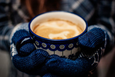 Cropped image of person holding coffee