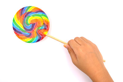 Close-up of hand holding multi colored umbrella