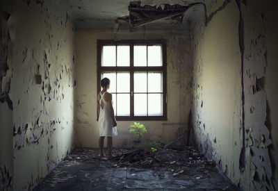 Woman standing in abandoned home