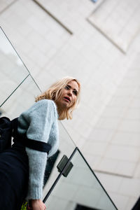 Beautiful woman standing against building