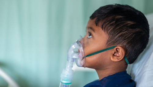 Close-up portrait of boy drinking water