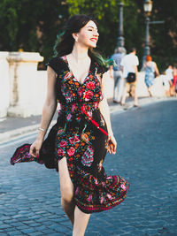 Smiling beautiful woman walking on street