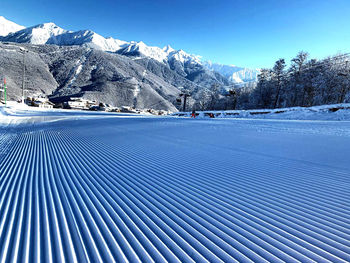 Scenic view of snowcapped mountains against blue sky