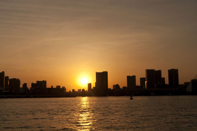 Silhouette of city at sunset