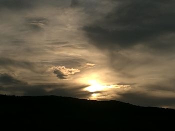 Low angle view of silhouette mountain against dramatic sky