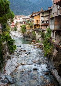 River by houses against sky