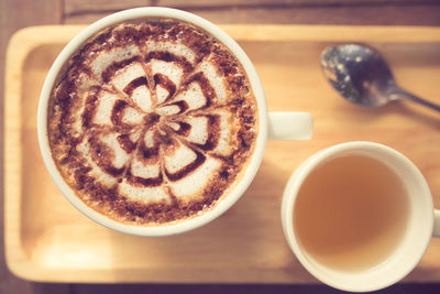 Close-up of cappuccino served on table