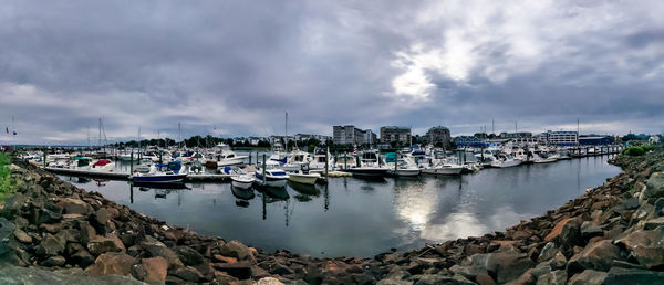 Sailboats moored in harbor