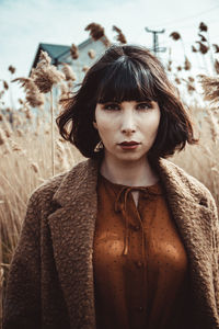 Portrait of young woman standing outdoors