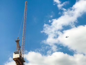 Low angle view of airplane flying against sky