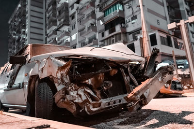 Cars on road by buildings in city