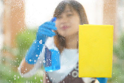 Woman cleaning glass window