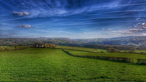 Scenic view of landscape against cloudy sky