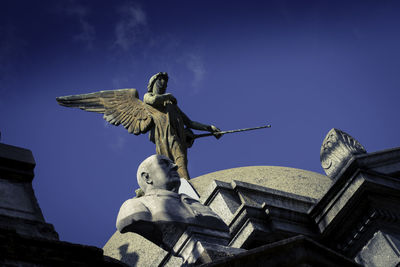 Low angle view of statue against sky