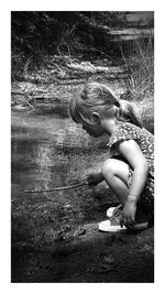 High angle view of girl sitting on field