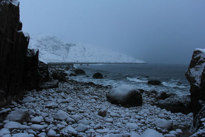 Scenic view of sea against clear sky during winter