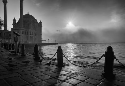 People on boat in city and fog