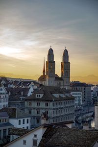 Buildings in city against sky during sunset