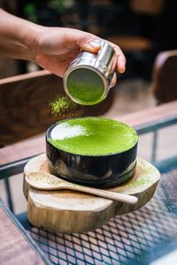 Close-up of hand holding tea cup