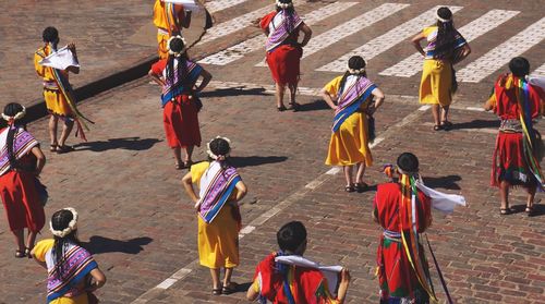 Rear view of people performing at street during inti raymi festival