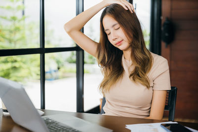 Young woman using laptop at office