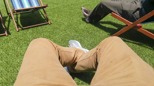 Low section of man relaxing on chair