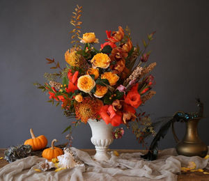 Close-up of orange flower vase on table