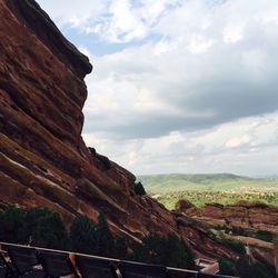 Rock formation on landscape against cloudy sky