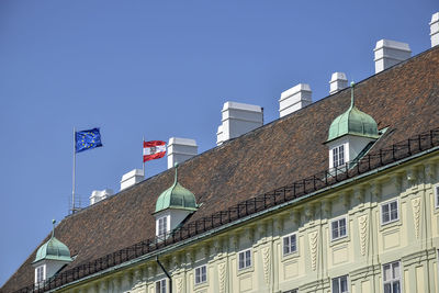 Flags of european union and austria on roof of building of residence hofburg. vienna, austria