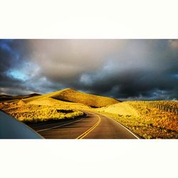 Scenic view of landscape against cloudy sky