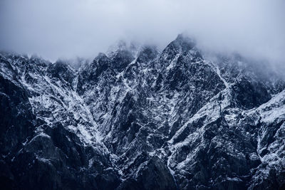 Close-up of snow on mountain against sky