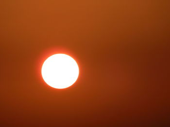 Low angle view of sun against orange sky