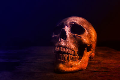 Close-up of human skull against black background