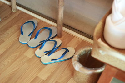 High angle view of shoes on wooden floor at home