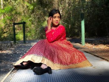 Portrait of woman sitting outdoors